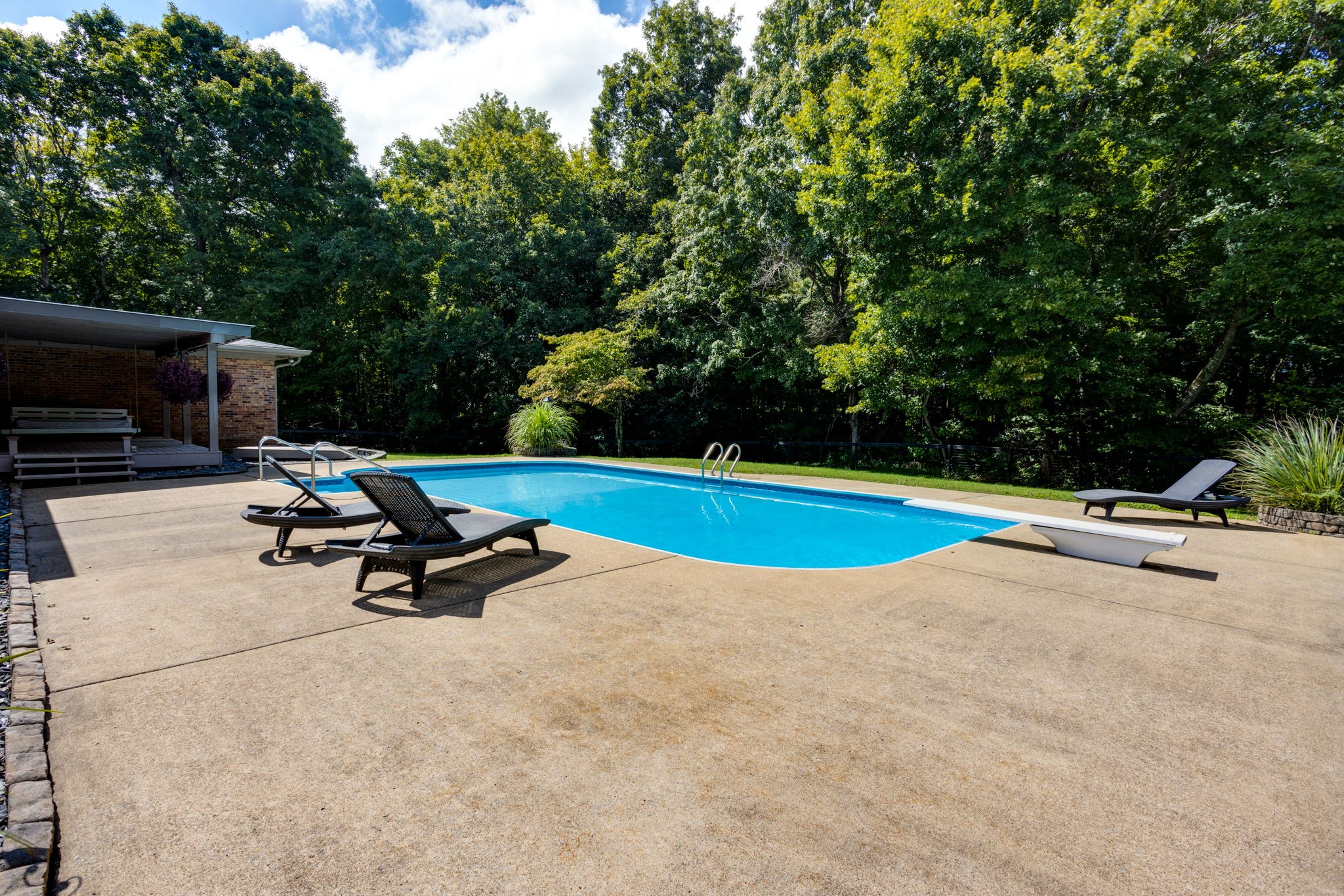 3557 Forest Park Road Springfield, TN 37172 - Photo 38 of 47 a view of a swimming pool with a bench and trees