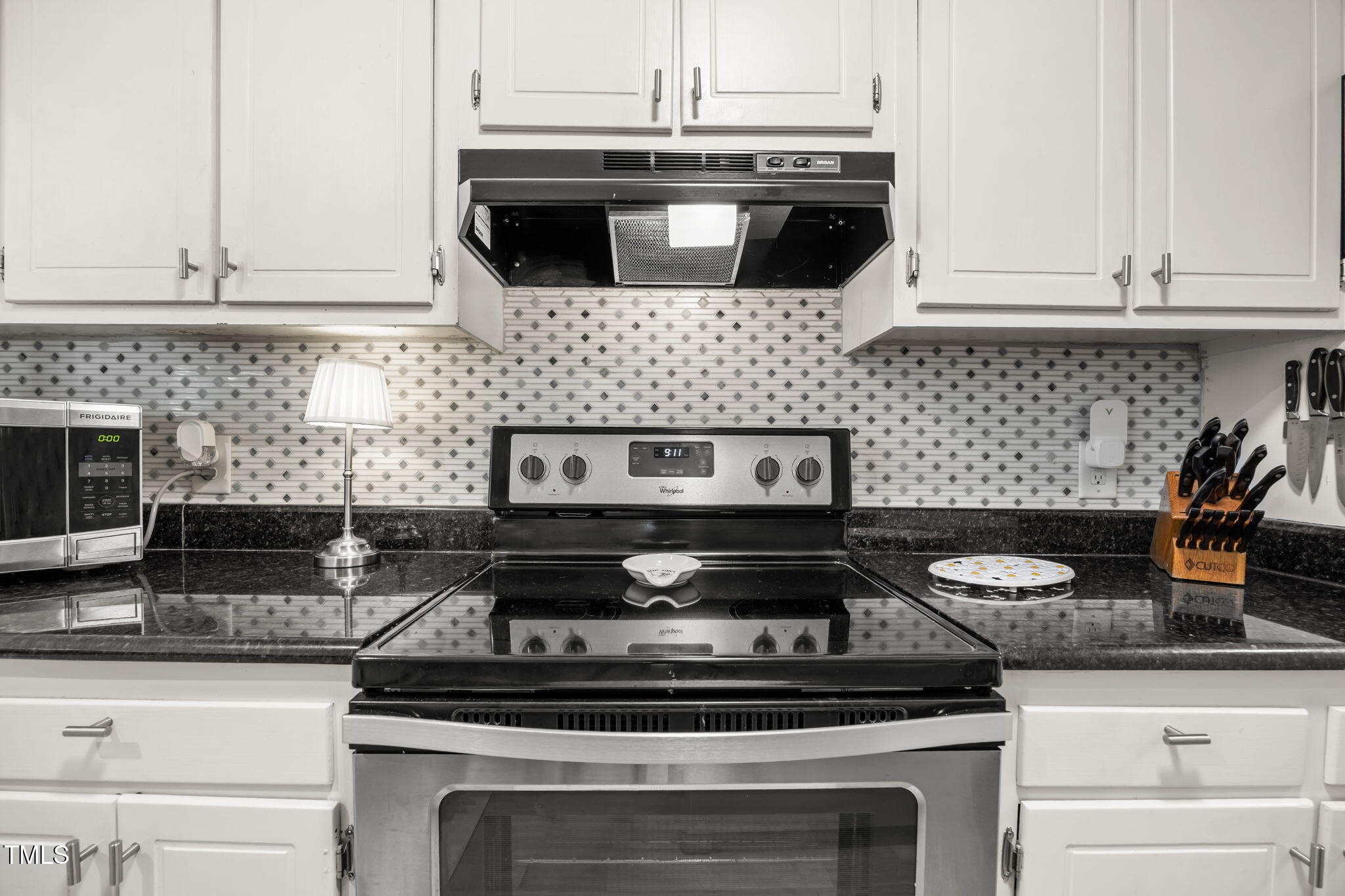 5024 Flint Ridge Place Raleigh, NC 27609 - Photo 7 of 46 The detailed tile back-,splash gives the kitchen a beautiful touch-clean, classic and low maintenance