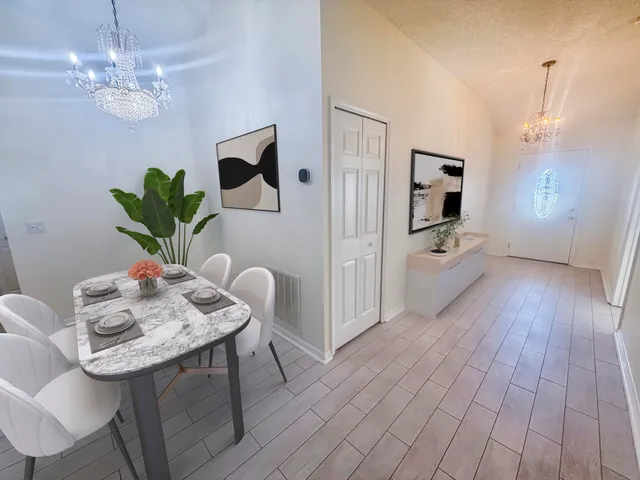 a view of a dining room with furniture wooden floor and chandelier