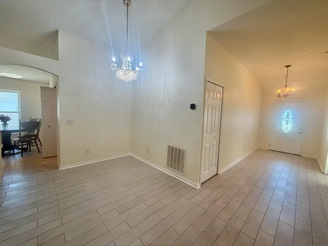 a view of a livingroom with wooden floor and a ceiling fan