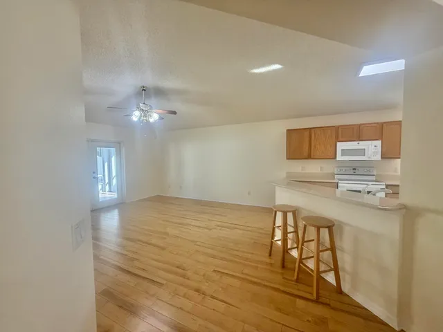a view of kitchen with furniture and wooden floor