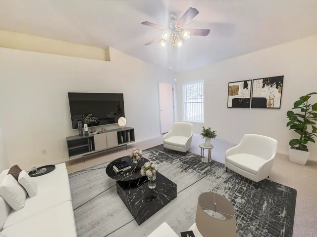 a living room with furniture a rug and a flat screen tv