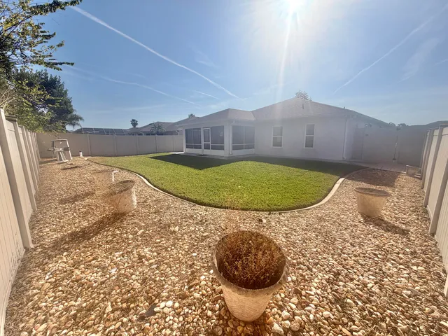 a view of a swimming pool with a yard