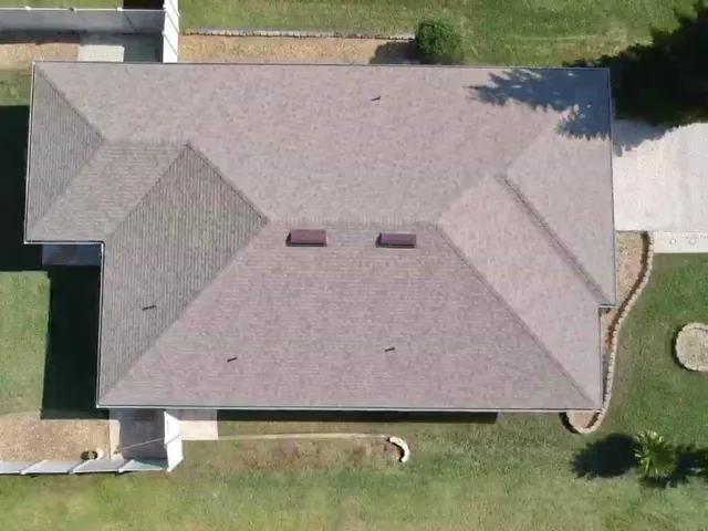a aerial view of a house with a yard