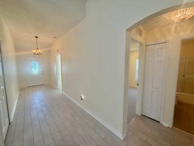 a view of an empty room and wooden floor