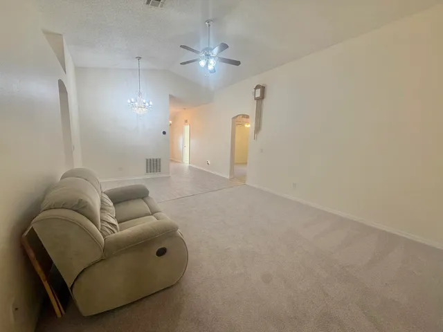 a living room with furniture and a chandelier