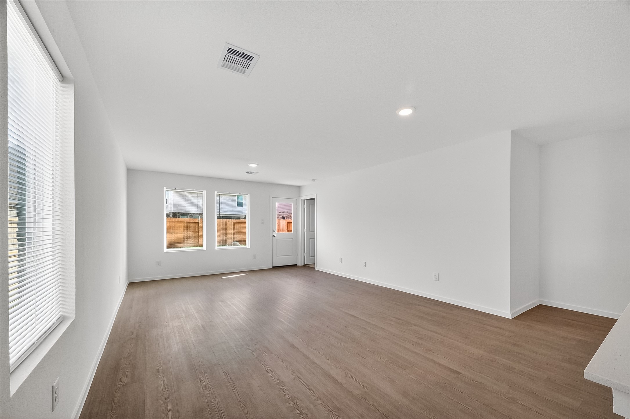 18510 Autumn Hts Lane Crosby, TX 77532 - Photo 7 of 29 an empty room with wooden floor and windows