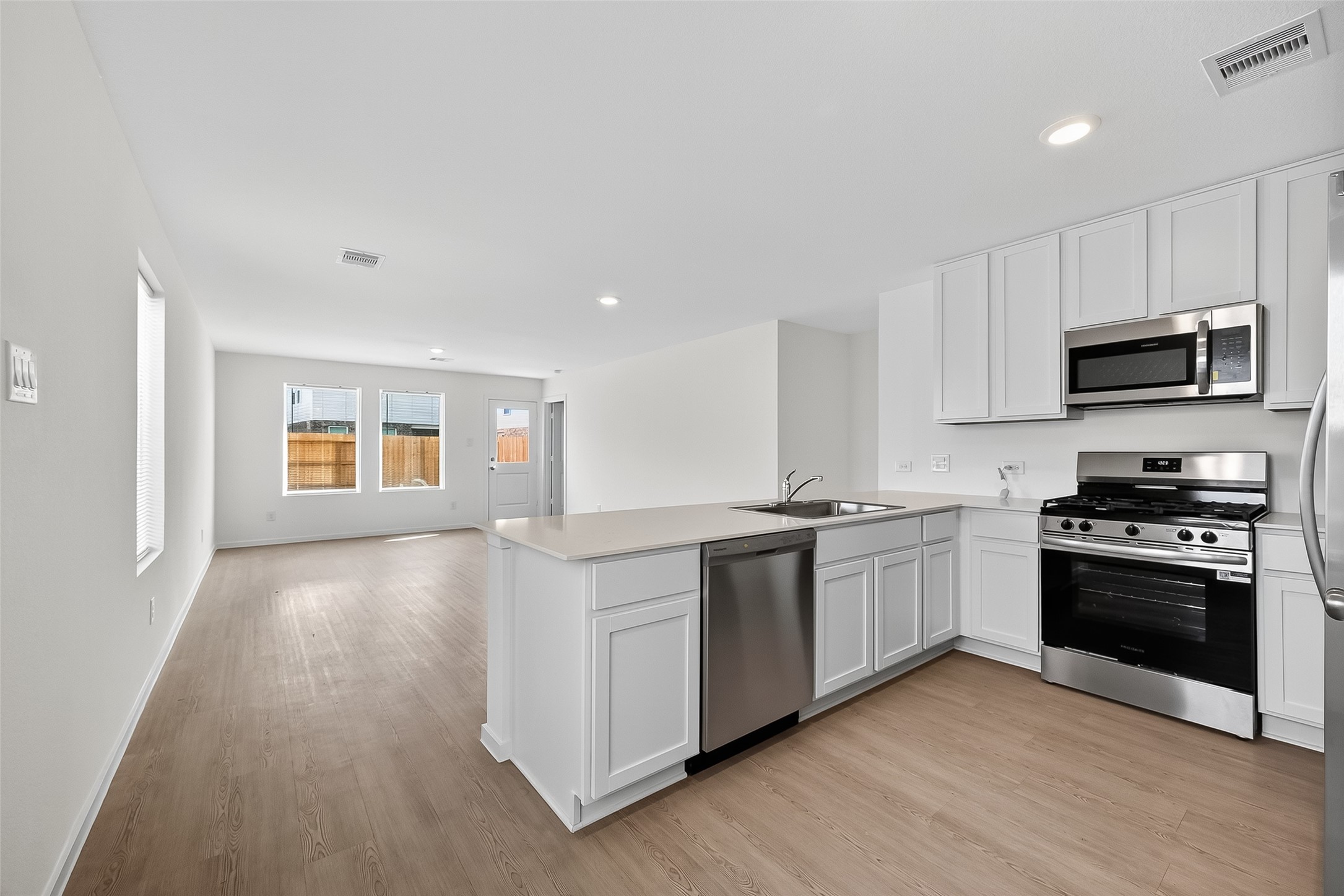 18510 Autumn Hts Lane Crosby, TX 77532 - Photo 8 of 29 a kitchen with stainless steel appliances granite countertop a stove a sink and a microwave
