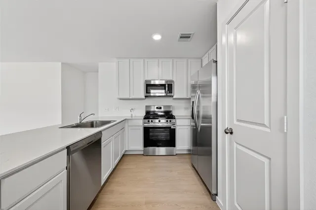 a kitchen with a sink stove and refrigerator
