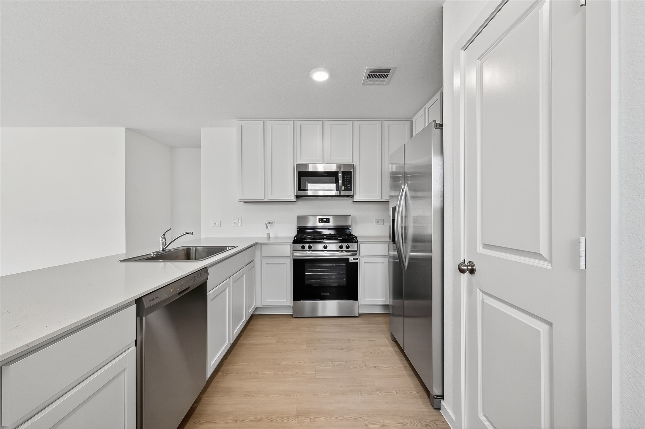 18510 Autumn Hts Lane Crosby, TX 77532 - Photo 9 of 29 a kitchen with a sink stove and refrigerator