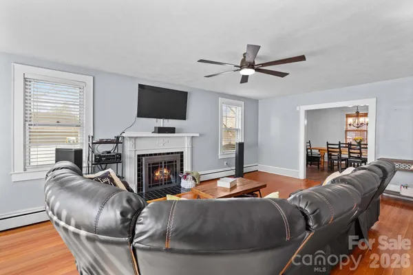 a living room with furniture and wooden floor