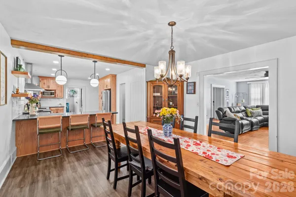 a kitchen with stainless steel appliances granite countertop a sink a stove and a wooden floors