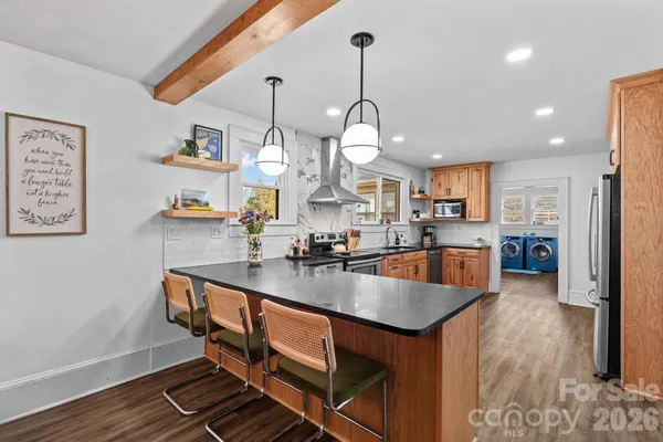 a kitchen with stainless steel appliances granite countertop a stove sink and cabinets