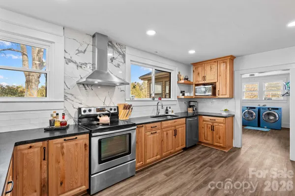 a kitchen with granite countertop white cabinets and window