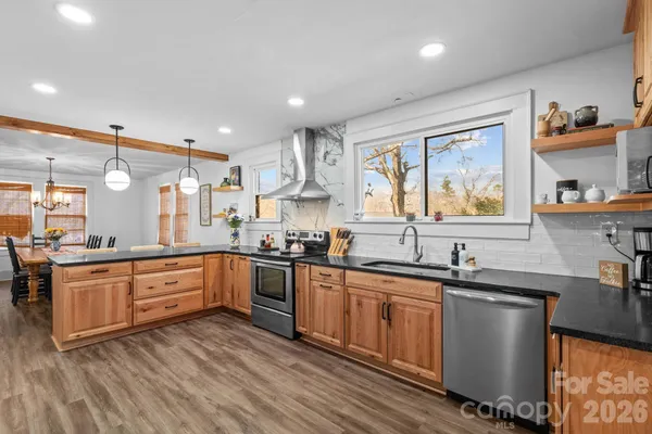 a kitchen with granite countertop stainless steel appliances a refrigerator and cabinets