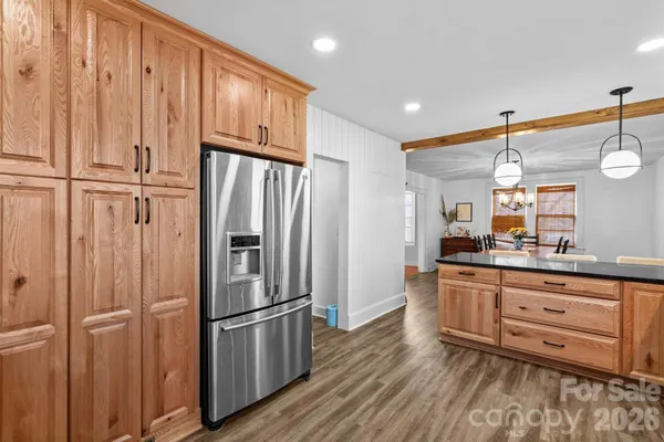 a view of kitchen with furniture and refrigerator