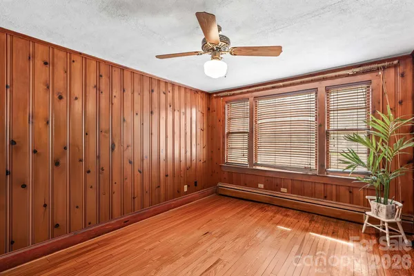 a view of an empty room and wooden floor