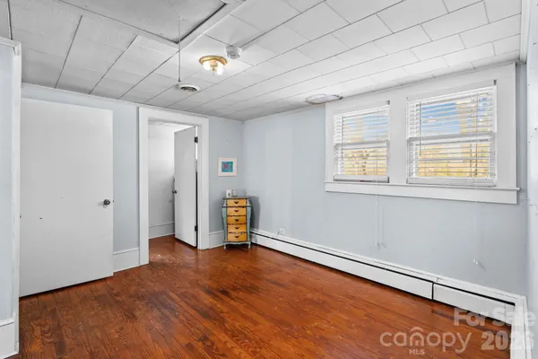 a view of a room with wooden floor