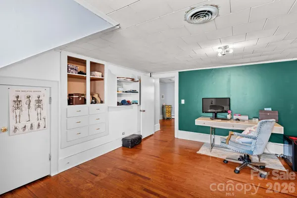 a spacious bedroom with a bed and a table in it