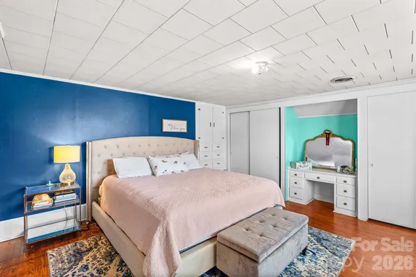 a bedroom with a large bed and a night stand