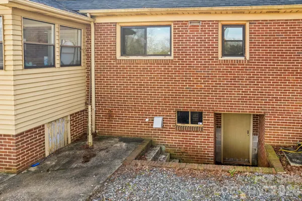 a front view of a house with swimming pool and sitting area
