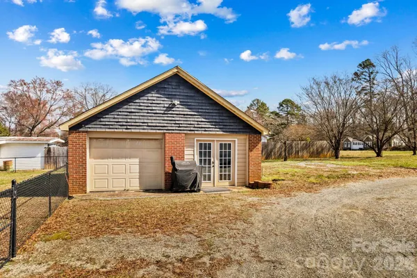 a view of yard with wooden fence