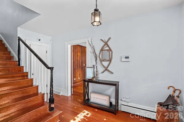 a view of a hallway with furniture and floor to ceiling window