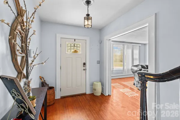 a living room with furniture floor to ceiling window and a flat screen tv