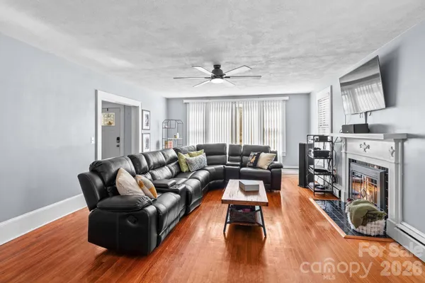 a living room with furniture fireplace and flat screen tv