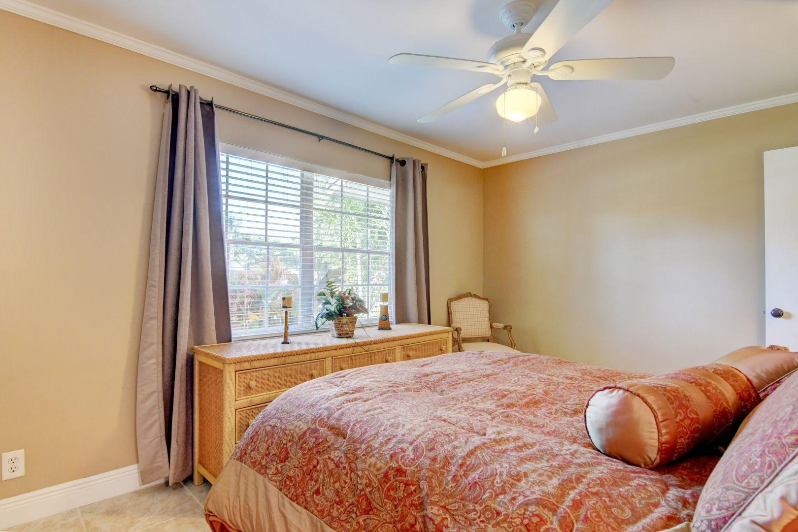 9989 Liberty Road Boca Raton, FL 33434 - Photo 18 of 44 a bedroom with a bed and a large window with outer view