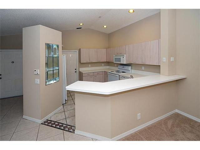 4417 Magnolia Ridge Drive Weston, FL 33331 - Photo 14 of 24 a kitchen with kitchen island a stove a sink and a refrigerator