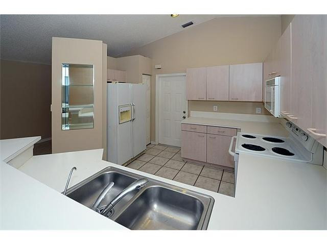 4417 Magnolia Ridge Drive Weston, FL 33331 - Photo 15 of 24 a kitchen with a sink a stove and cabinets