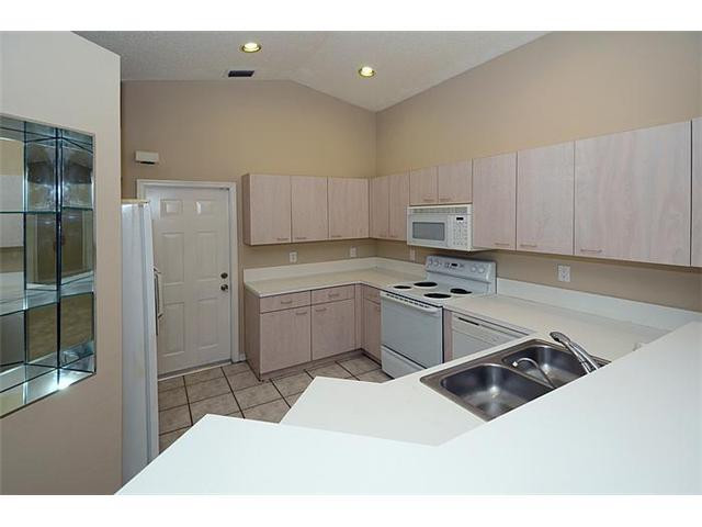 4417 Magnolia Ridge Drive Weston, FL 33331 - Photo 16 of 24 a kitchen with a sink appliances and cabinets