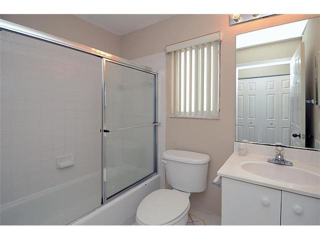 4417 Magnolia Ridge Drive Weston, FL 33331 - Photo 3 of 24 a bathroom with a granite countertop sink toilet a mirror and shower