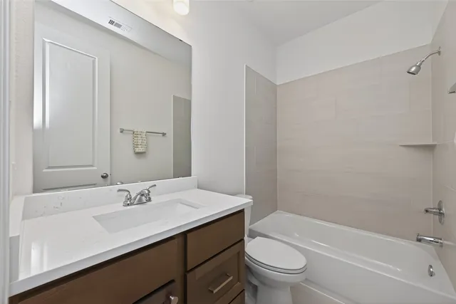 a bathroom with a sink a toilet and a bathtub