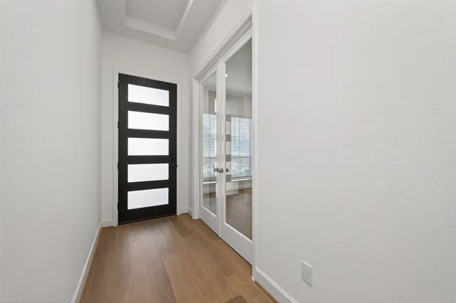 wooden floor in a room next to a window