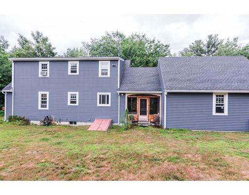 225 Locke Road Ashby, MA 01431 - Photo 21 of 27 a view of a yard in front of a house with plants and large tree