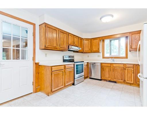 225 Locke Road Ashby, MA 01431 - Photo 3 of 27 a kitchen with stainless steel appliances granite countertop a stove a sink dishwasher and a refrigerator with wooden cabinets