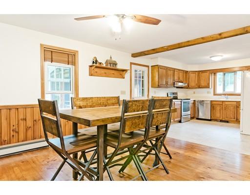 225 Locke Road Ashby, MA 01431 - Photo 7 of 27 a dining room with a wooden table and chairs