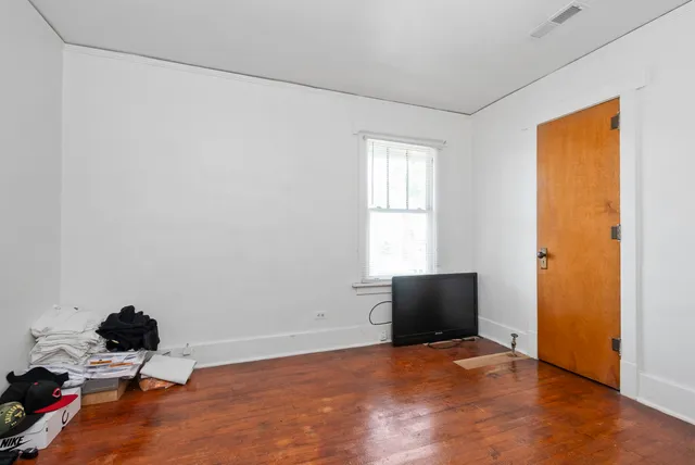 an empty room with a closet and a window
