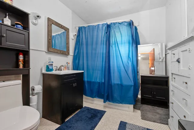 a bathroom with a toilet a sink and a window