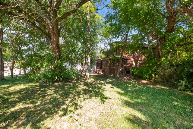 a backyard of a house with a table and chairs