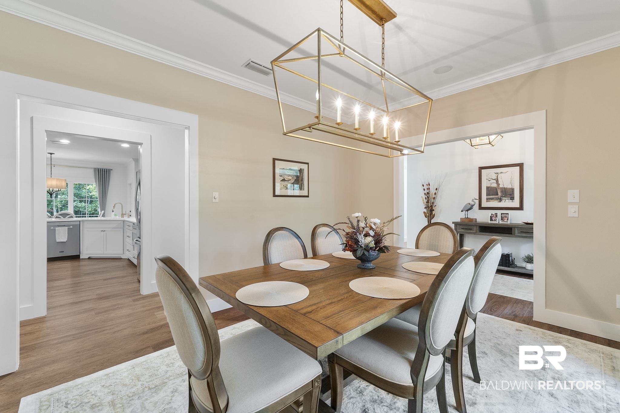 4451 Millhouse Road Gulf Shores, AL 36542 - Photo 16 of 50 Dining area with hardwood / wood-style flooring and ornamental molding