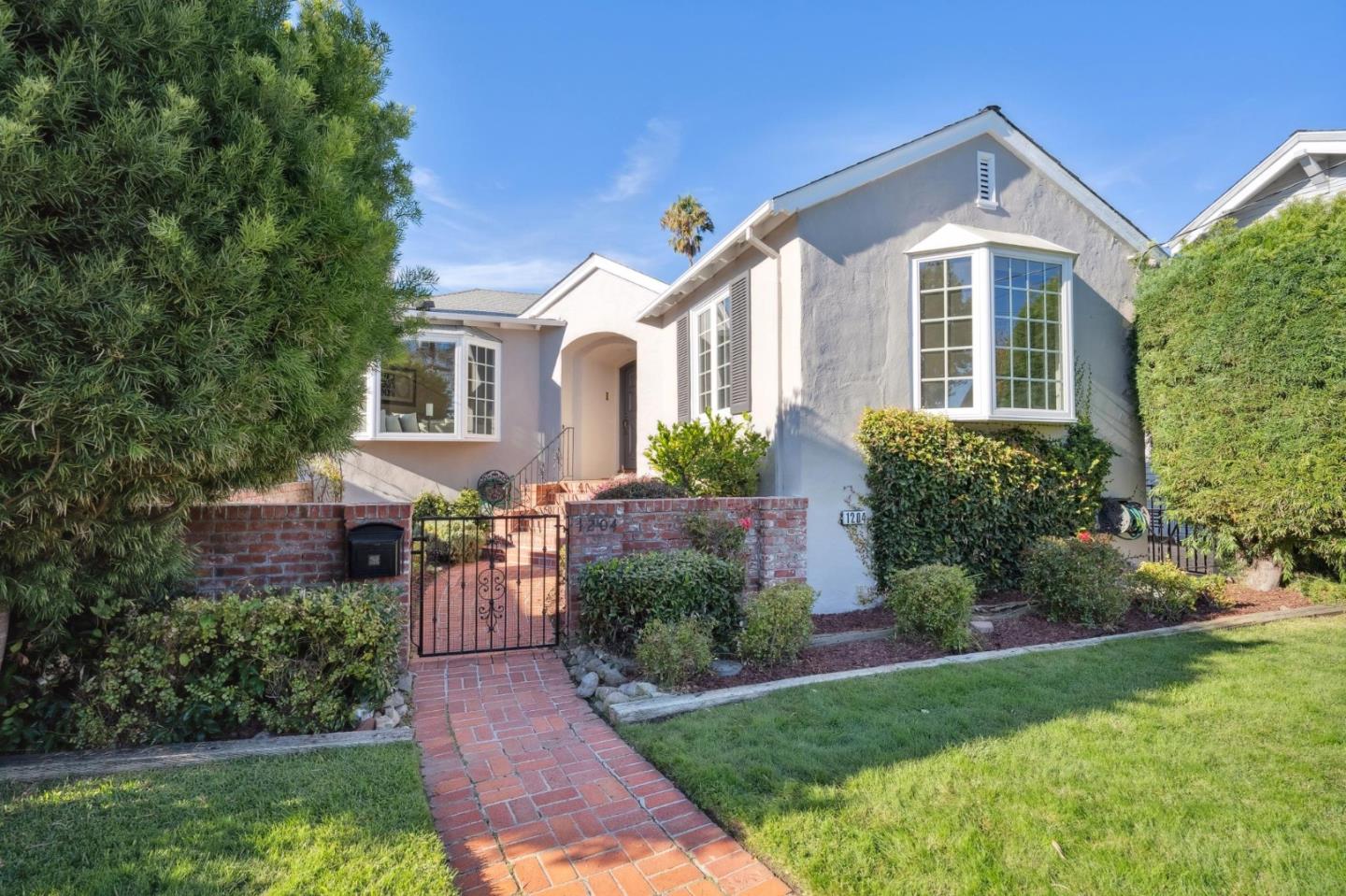 1204 Edgehill Drive Burlingame, CA 94010 - Photo 1 of 38 a front view of a house with a yard