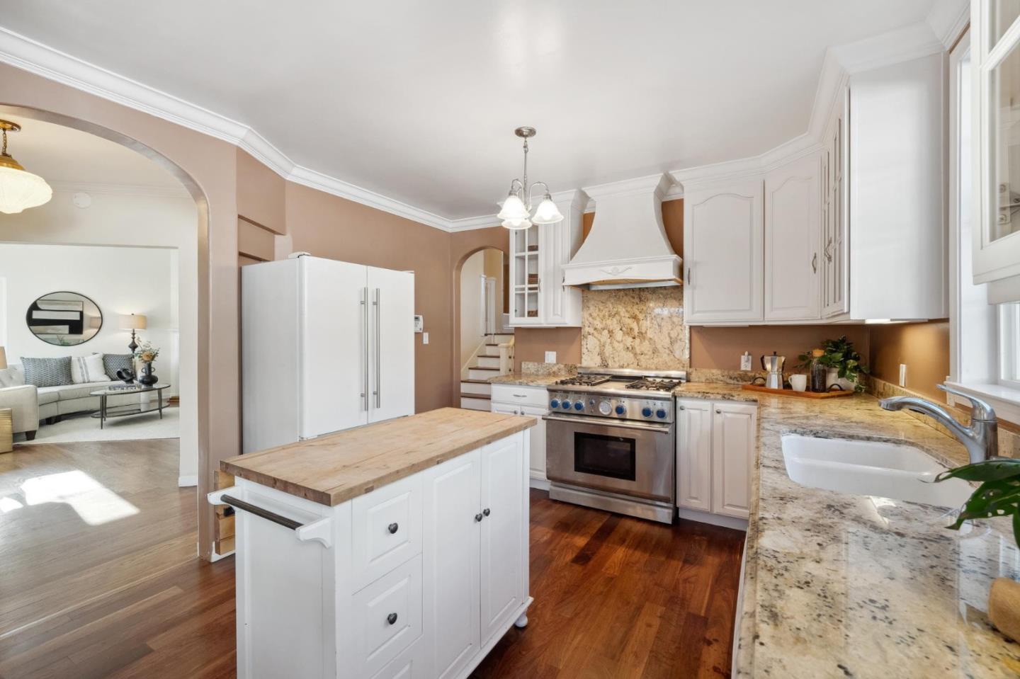 1204 Edgehill Drive Burlingame, CA 94010 - Photo 13 of 38 a kitchen with granite countertop white cabinets and appliances