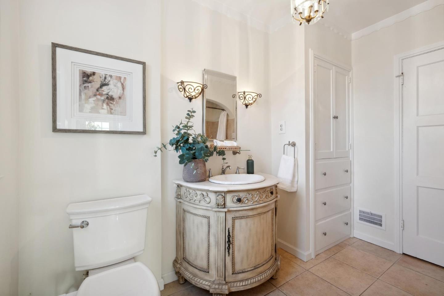 1204 Edgehill Drive Burlingame, CA 94010 - Photo 19 of 38 a bathroom with a toilet a sink and a mirror