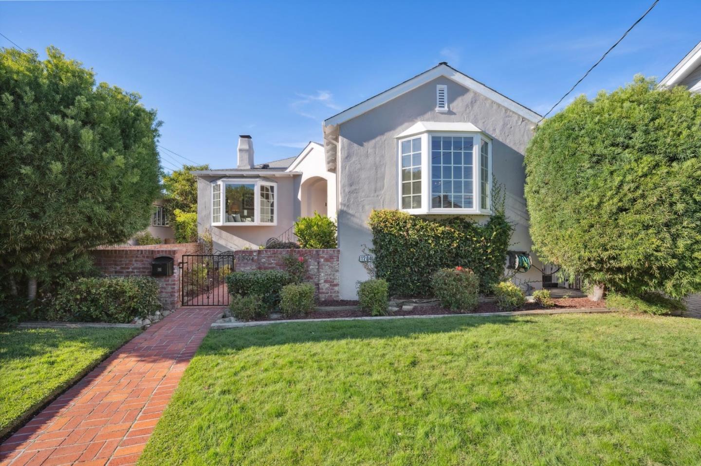1204 Edgehill Drive Burlingame, CA 94010 - Photo 2 of 38 a front view of a house with a yard