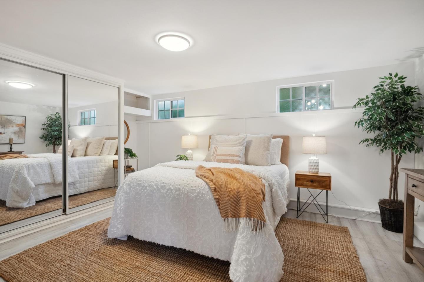 1204 Edgehill Drive Burlingame, CA 94010 - Photo 25 of 38 a bedroom with a bed and a potted plant with wooden floor