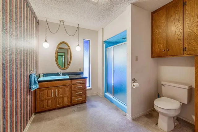 a bathroom with a toilet a sink and a mirror