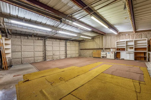an aerial view of a house with a yard basket ball court and outdoor seating